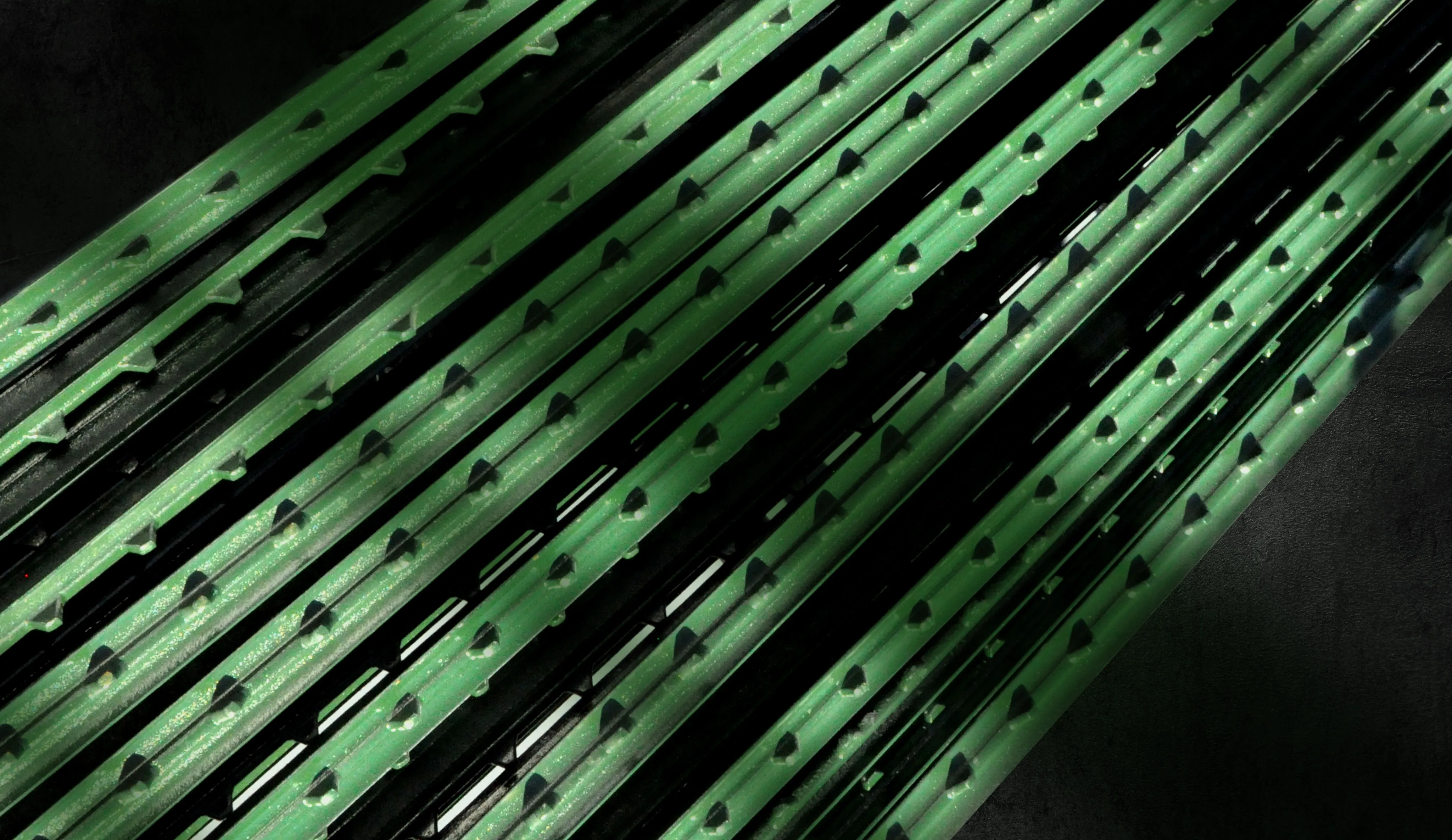 A stack of green painted agricultural t-post fencing