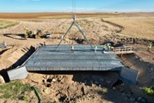 A completed bridge span being lowered into place.