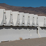 Precast concrete highway (jersey) barriers stacked up outside.