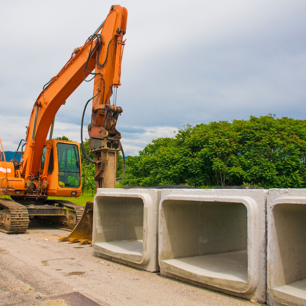 Precast concrete box culverts alongside construction equipment